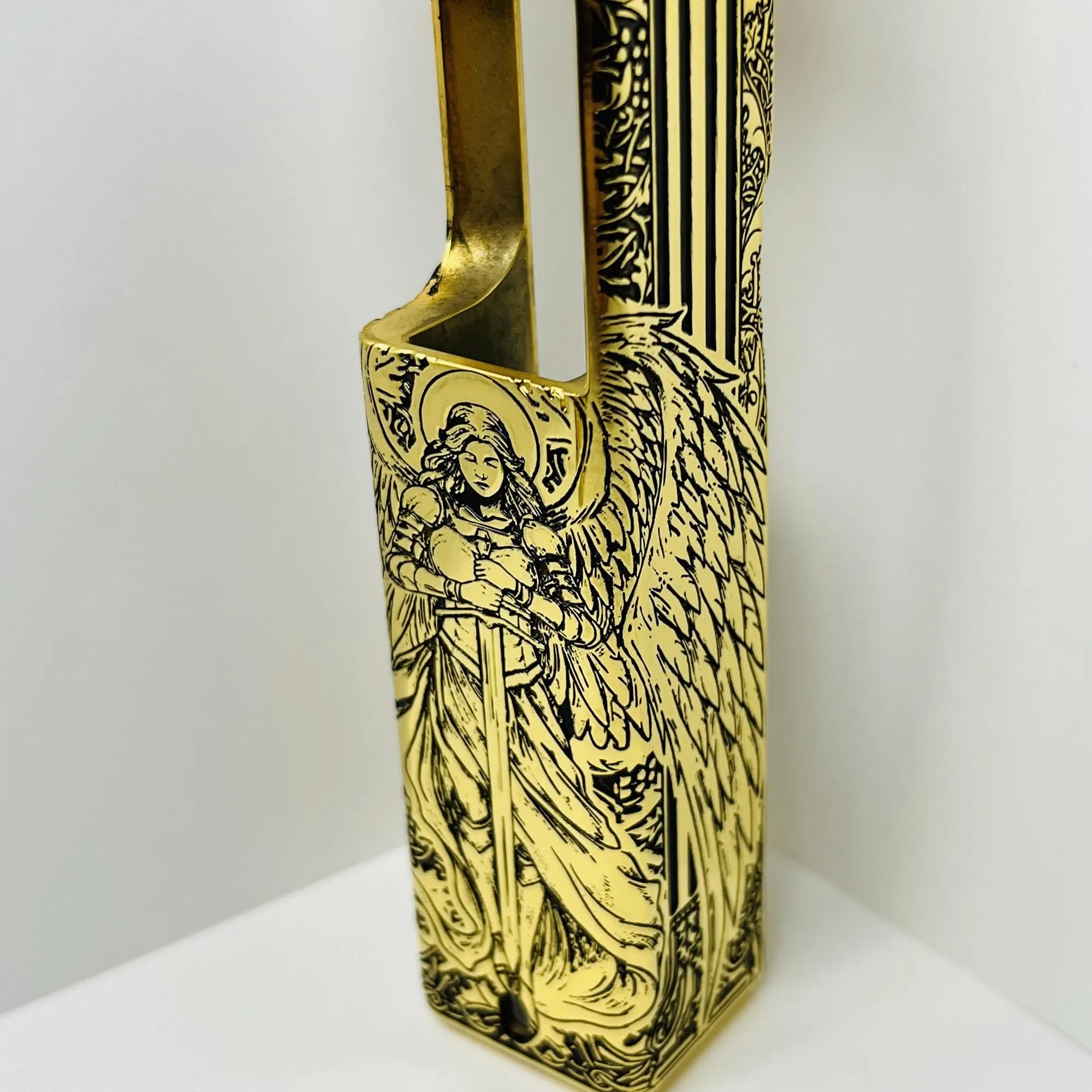 Gold-plated pistol slide hand engraved with a detailed archangel figure