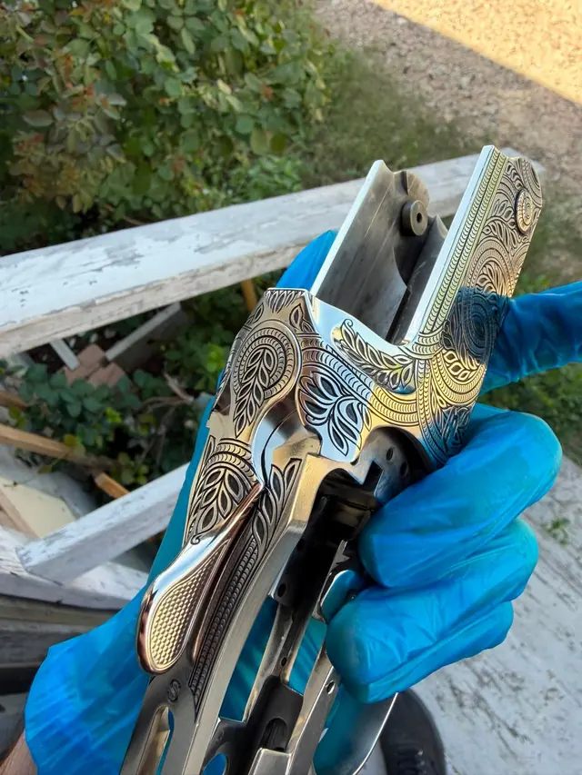 Engraved break-action firearm receiver with floral scroll pattern