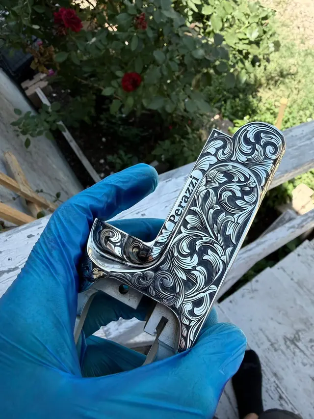Engraved trigger guard with floral scroll pattern