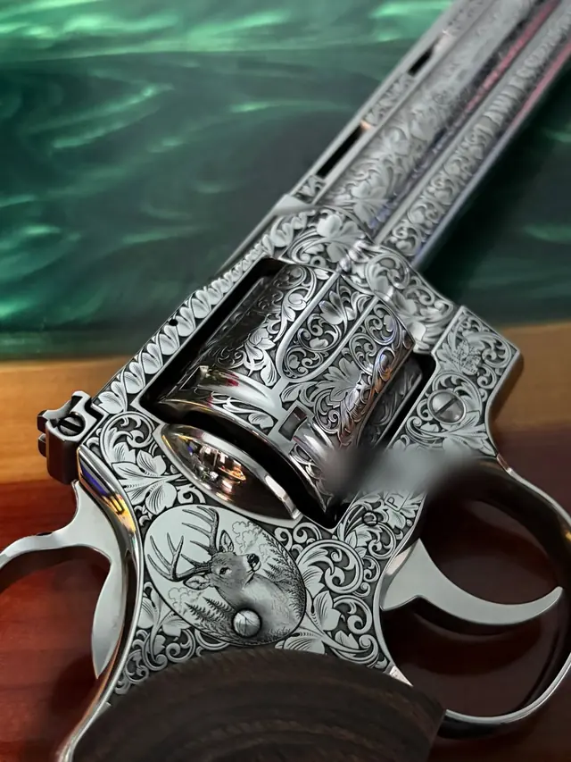 Detail view of a deer relief scene on a revolver frame