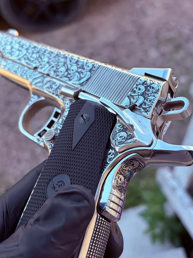 Pistol with a full relief skull motif engraving