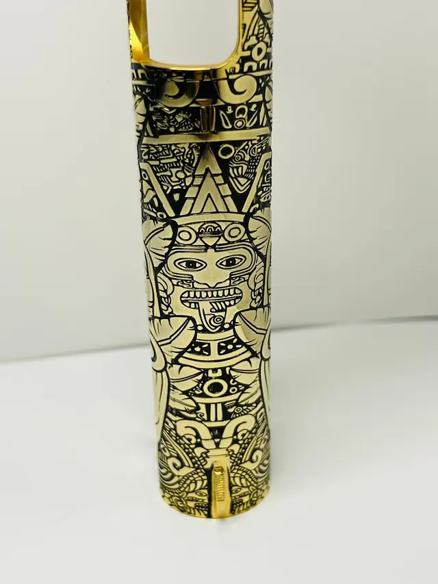 Gold pistol frame engraved with a Mesoamerican relief design