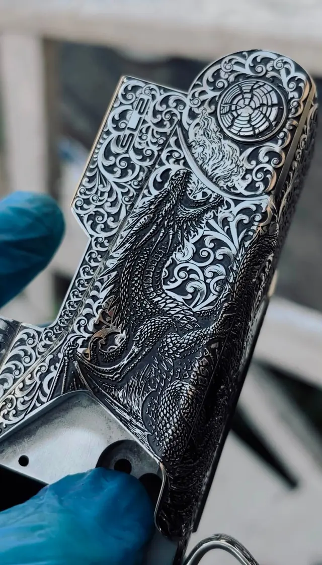 Engraved floorplate with a dragon relief design and scrollwork