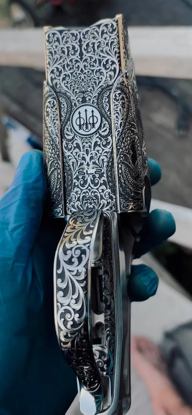 Engraved shotgun trigger guard with tight floral scroll detail
